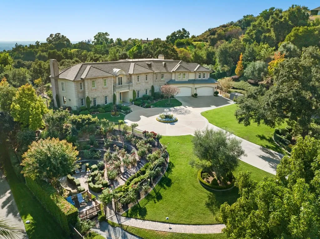 430 Long Canyon Road Home in Bradbury, California. Discover opulent living in the prestigious gated community of Bradbury Estates with this grand 6-bedroom, 9-bathroom estate spanning over 8,300 square feet on nearly three acres. The stately ambience begins at the grand entrance with a statement fountain and motor court.