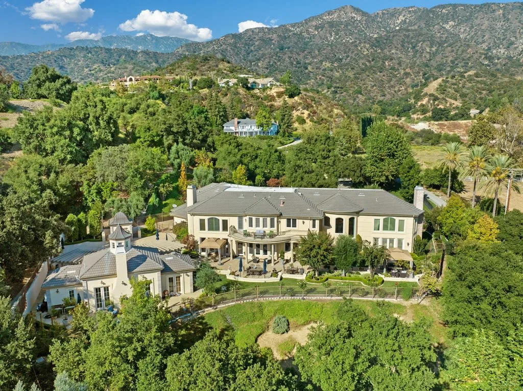 430 Long Canyon Road Home in Bradbury, California. Discover opulent living in the prestigious gated community of Bradbury Estates with this grand 6-bedroom, 9-bathroom estate spanning over 8,300 square feet on nearly three acres. The stately ambience begins at the grand entrance with a statement fountain and motor court.