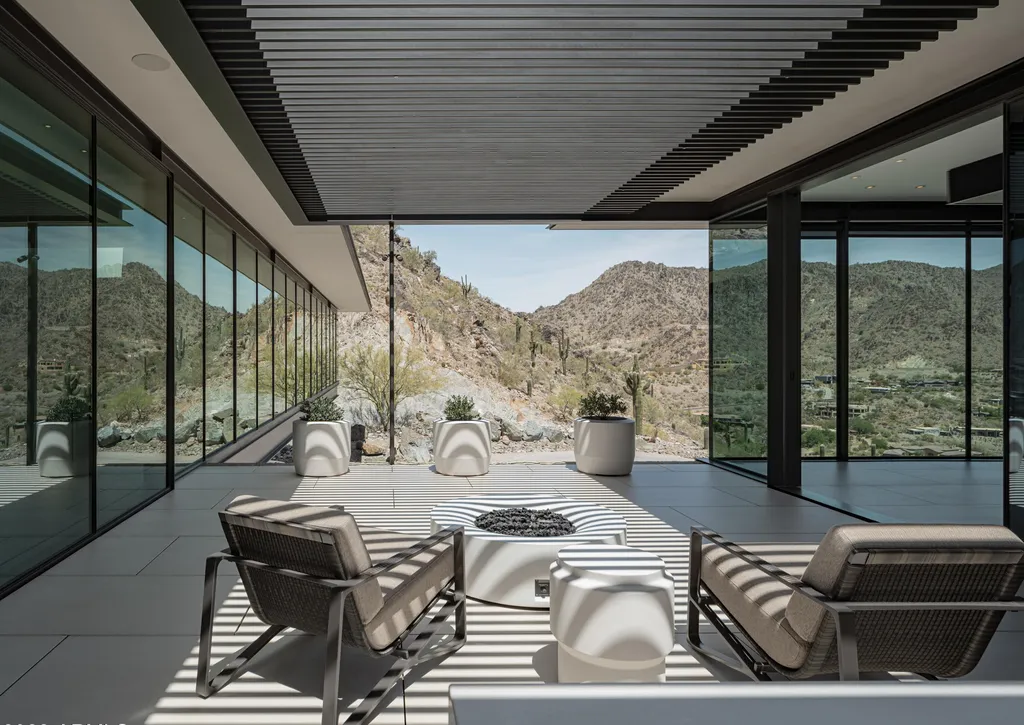 4301 E Upper Ridge Way Home in Paradise Valley, Arizona. Perched between two mountain peaks, the Upper Ridge Residence is an 8,000+ sf modern marvel designed by The Construction Zone. Featuring panoramic Valley of the Sun views, this steel and glass pavilion offers the highest level of craftsmanship.