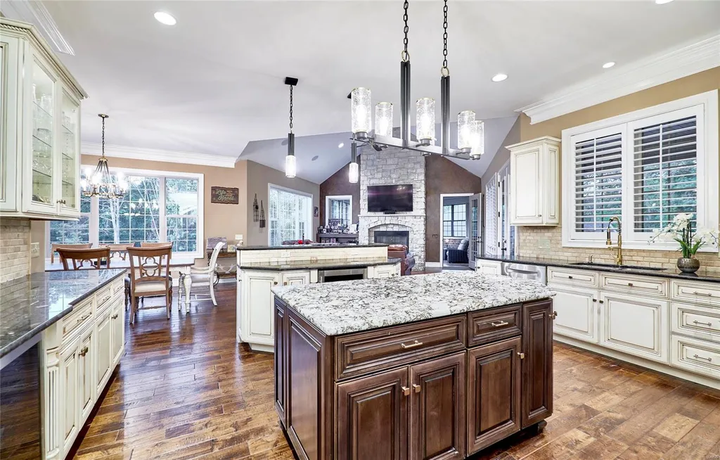 965 Stonecastle Drive Home in O'Fallon, Missouri. Discover the epitome of luxury living in this custom-built estate in Stonecastle subdivision, St. Paul. Boasting 5 bedrooms, 7 bathrooms, two kitchens, a home theater, in-ground hot tub, a 1400 sqft guest house, a 2000 sqft gym, and a 5-car oversized garage with a separate suite, this property offers unparalleled amenities for an elevated lifestyle.