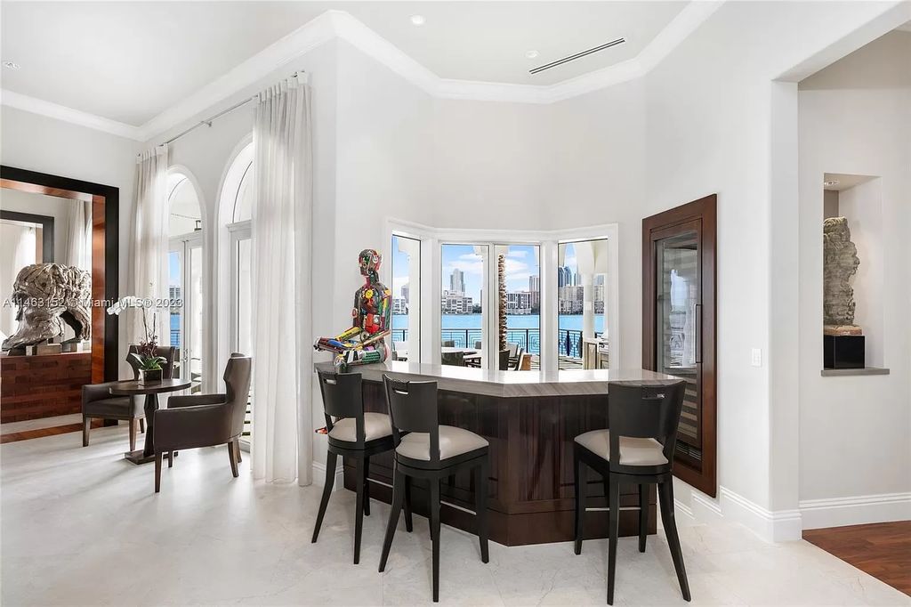 Discover the pinnacle of island living at 4042 Island Estates Dr, Aventura, FL. This impressive 3-level sanctuary, crafted in 2001, presents 5 bedrooms with private waterfront balconies, 6 bathrooms, and 2 half baths within its 7,796 square feet.