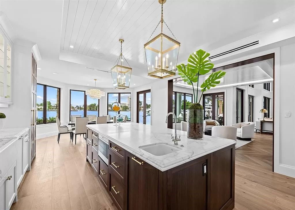 Immerse yourself in the epitome of the "South Florida Lifestyle" at this exquisitely renovated 6-bed, 8-bath West Indies Oasis at 1812 SE 14th St, Fort Lauderdale, FL. This 7,221 sq ft estate boasts a grand Great Room with 20' ceilings and panoramic water views, a media room, and a chef's kitchen with a La’Corneu gas range.