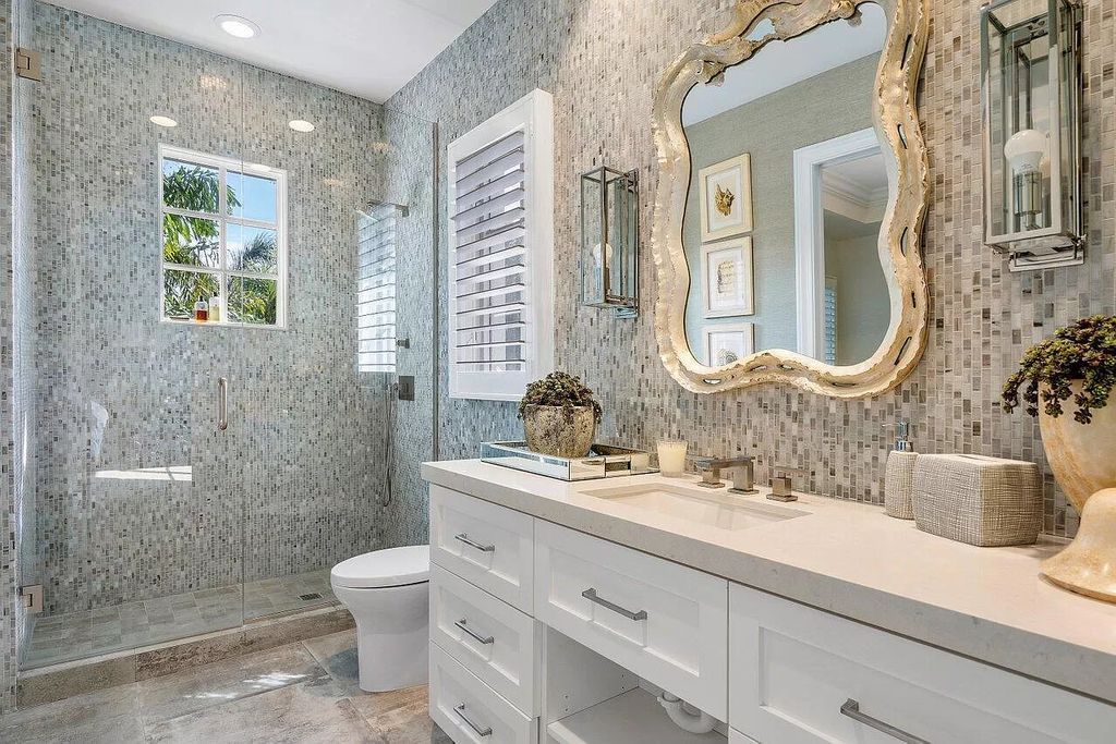 Discover an exquisite 7-bedroom, 9-bathroom haven at 410 N Ocean Blvd, Delray Beach, FL 33483, boasting 10,385 square feet of meticulously designed luxury by renowned architect Jeff Strasser. Every corner reflects a commitment to unparalleled craftsmanship, with lavish finishes and handpicked appointments that speak to the substantial investment poured into this masterpiece.