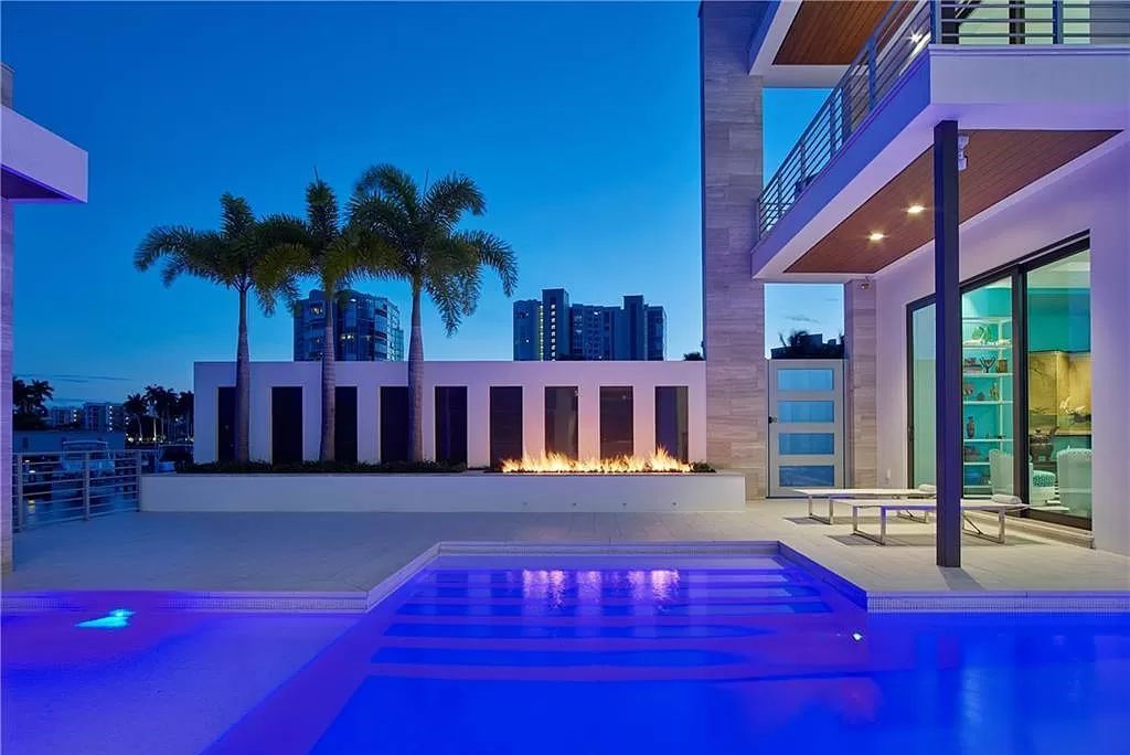 Discover modern luxury at its finest in this Naples, Florida gem at 4100 Gulf Shore Blvd N. A minimalist interior with vibrant pops of color and geometric architecture seamlessly merges with breathtaking Venetian Bay views through walls of glass.