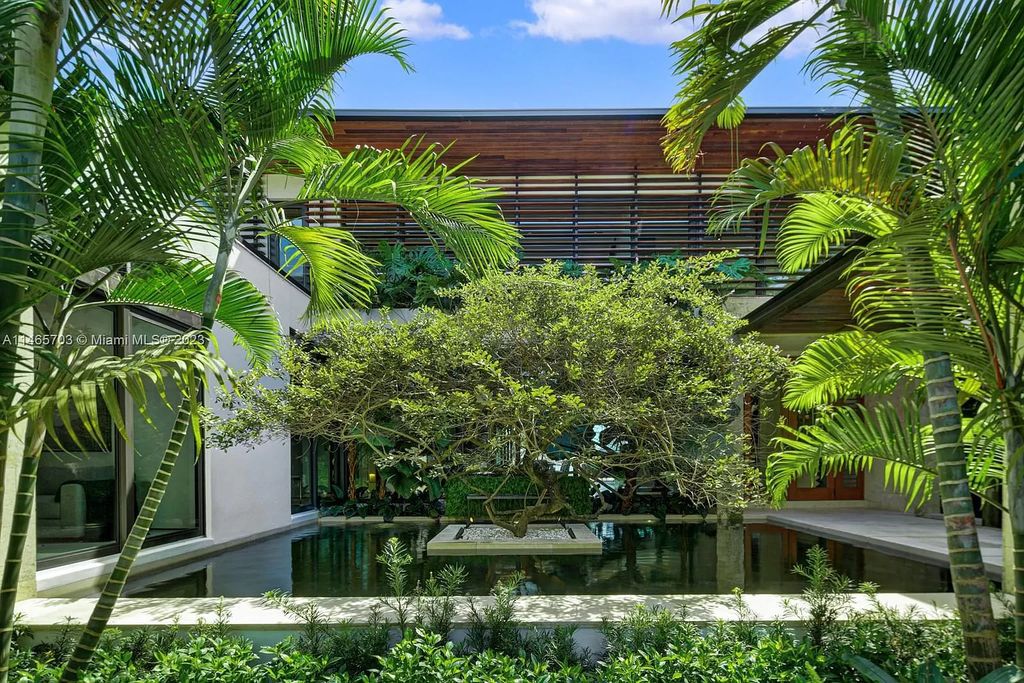Welcome to Villa Aman, a luxurious modern masterpiece located at 1826 W 23rd St, Miami Beach, FL. Crafted by Cesar Molina, this bespoke property features 7 suites, including a guest pavilion, complemented by a fireplace room, elegant dining with a wine cellar, and an office overlooking a serene koi pond.