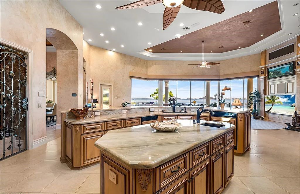 Discover an extraordinary waterfront estate at 11250 Longwater Chase Ct, Fort Myers, Florida. This opulent home, crafted by HARBOURSIDE CUSTOM HOMES, offers an unparalleled lifestyle in Gulf Harbour Yacht & Country Club.
