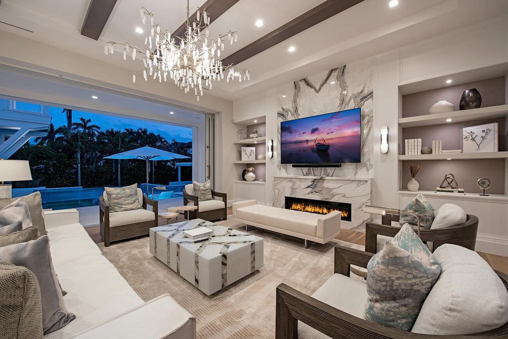 Discover the epitome of luxury living in Naples, Florida at this exquisite 5-bedroom, 7-bath cottage-style home located just moments from the Gulf. Designed by renowned developer VIV Homes in 2022, the property seamlessly blends classic charm with modern sophistication, boasting Italian-made custom closets, a chef's kitchen with premium appliances, and a state-of-the-art security system.