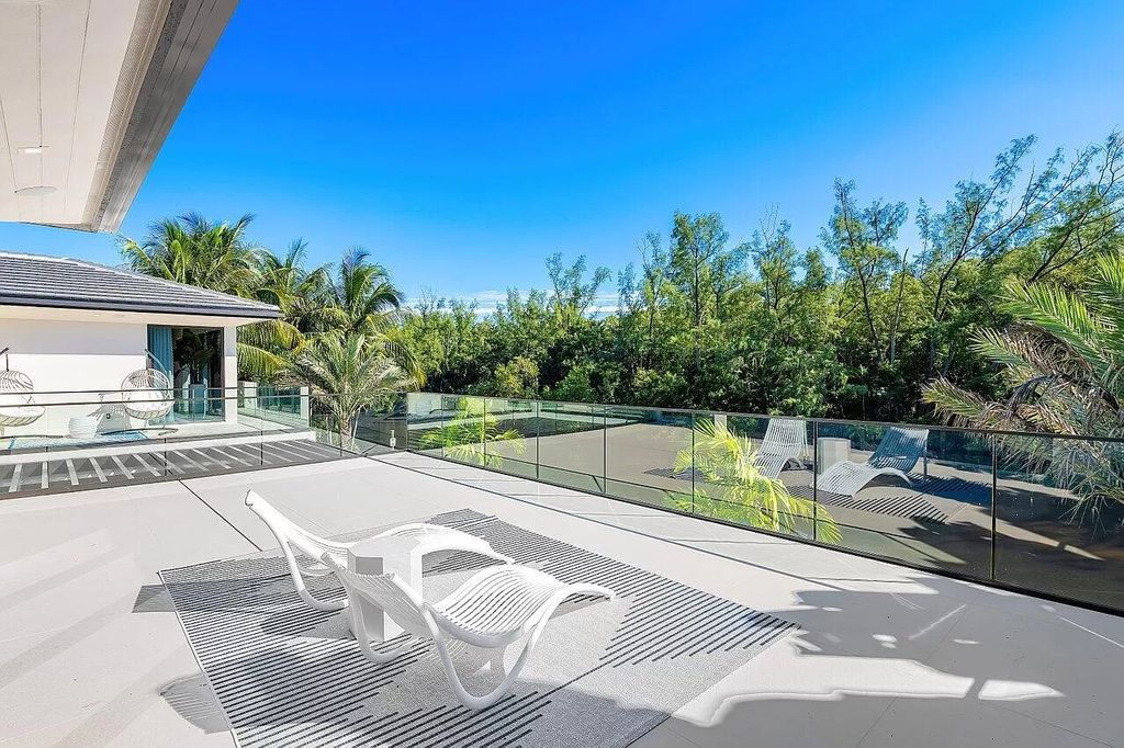 Experience the epitome of luxury living at this brand new contemporary waterfront masterpiece in Boca Raton's prestigious Royal Palm Yacht & Country Club. Spanning 9,030 square feet with 6 bedrooms and 9 baths, this turnkey estate by Albanese & Sons, BE Designs, and Zelman Design offers a 2-story lit foyer, a lavish living room with serene Capone Island views, a dream chef's kitchen with top-tier appliances, a resort-style pool and spa, and smart house technology.