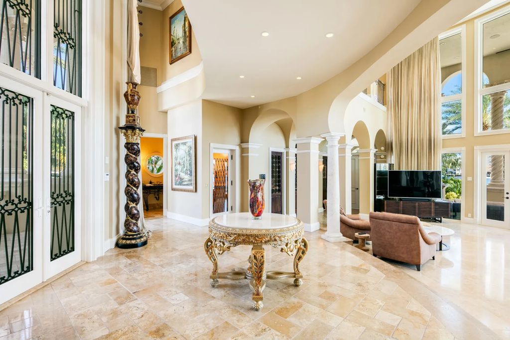 Discover the pinnacle of luxury living at 2 Pelican Dr, a gated point lot estate in Fort Lauderdale's Las Olas community. This stunning 5-bedroom, 8-bathroom home, with over 10,000 square feet of living space, showcases extensive upgrades, marble flooring, a smart-home system, elevator, and a whole-house generator.