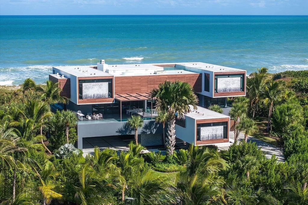 Discover an exceptional oceanfront retreat on Hutchinson Island, where modern design meets luxurious functionality. This stunning estate, nestled within the gated enclave of Galleon Bay on a sprawling 2.3+ acre double lot, boasts 239 feet of unobstructed oceanfront, offering an unparalleled coastal panorama.