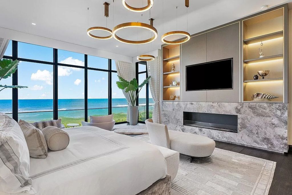 Discover an exceptional oceanfront retreat on Hutchinson Island, where modern design meets luxurious functionality. This stunning estate, nestled within the gated enclave of Galleon Bay on a sprawling 2.3+ acre double lot, boasts 239 feet of unobstructed oceanfront, offering an unparalleled coastal panorama.