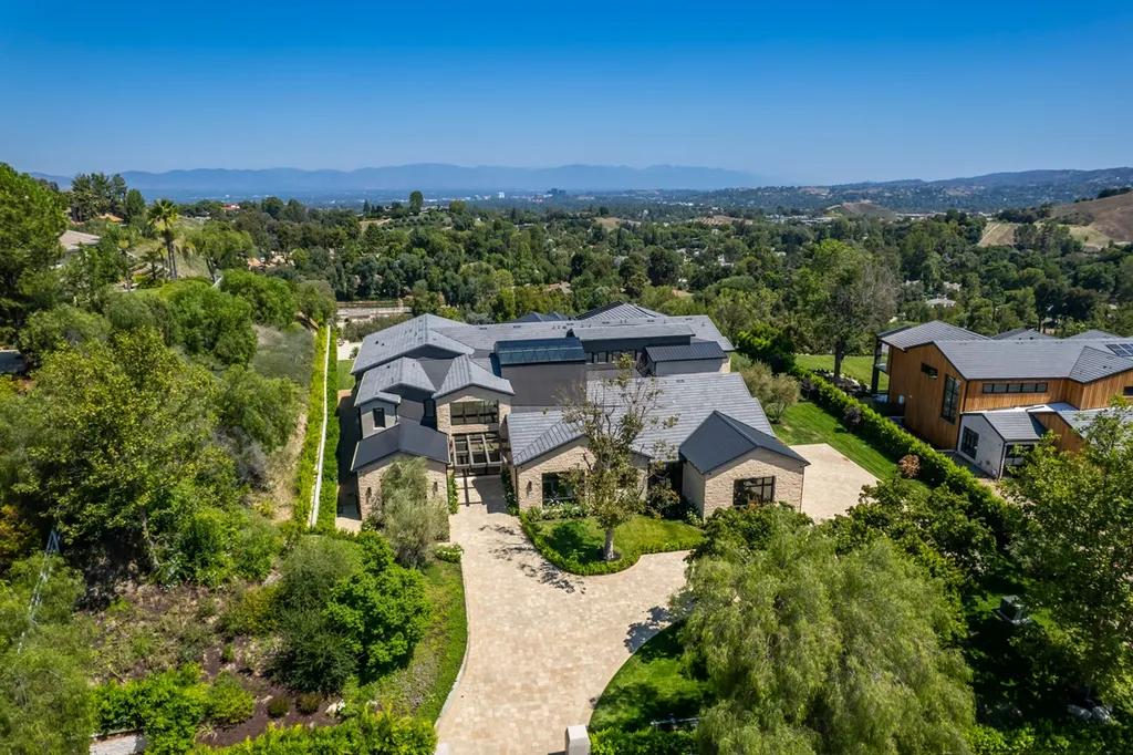 25079 Jim Bridger Road Home in Calabasas, California. Discover the epitome of refined luxury in this stunning new estate on a beautiful 1.6-acre lot in Hidden Hills. The open floor plan features a chef's kitchen, butler's pantry, and expansive great room with sliding walls of glass. Enjoy amenities like a home theater, large game room, and an oversized gym & spa.
