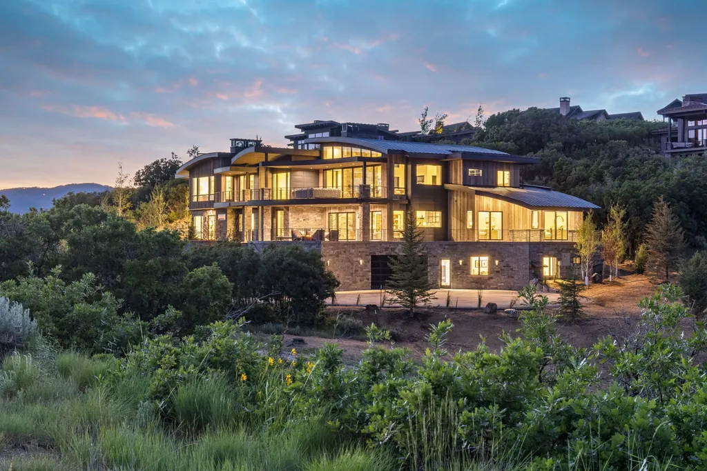 2687 East Canyon Gate Road Home in Park City, Utah. Immerse yourself in the pinnacle of luxury living with this James L. Carroll-designed estate in Promontory Ridge, Park City. Boasting over 8,600 sq ft of opulent space, panoramic mountain views, and exquisite finishes, this property is a true architectural masterpiece.