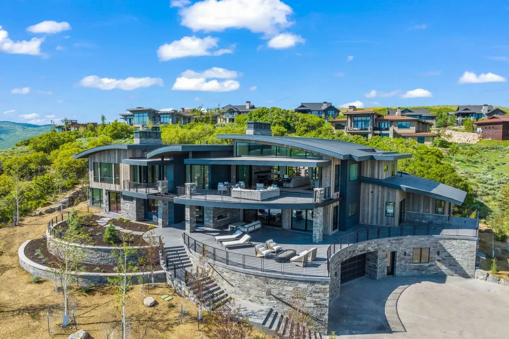 2687 East Canyon Gate Road Home in Park City, Utah. Immerse yourself in the pinnacle of luxury living with this James L. Carroll-designed estate in Promontory Ridge, Park City. Boasting over 8,600 sq ft of opulent space, panoramic mountain views, and exquisite finishes, this property is a true architectural masterpiece.