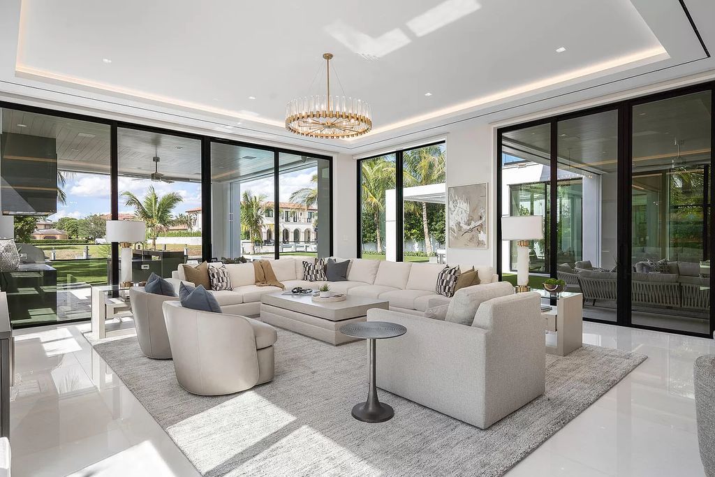 Indulge in the epitome of waterfront luxury at this 10,784-square-foot estate in Royal Palm Yacht & Country Club. Crafted by Wietsma Lippolis Construction, this masterpiece boasts six bedroom suites, expansive living areas curated by Artisan Interiors, and cutting-edge Crestron home technology.