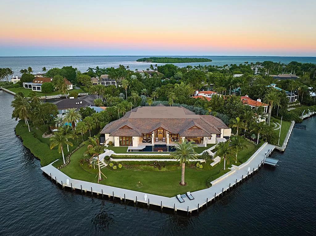 Discover a newly constructed 5,700 sq ft canal-front sanctuary at 38 Sunset Cay Rd, Key Largo, FL, nestled in the prestigious Ocean Reef Club. This contemporary masterpiece offers 280 ft of seawall dockage, a 60' lap pool, and captivating outdoor entertainment areas.