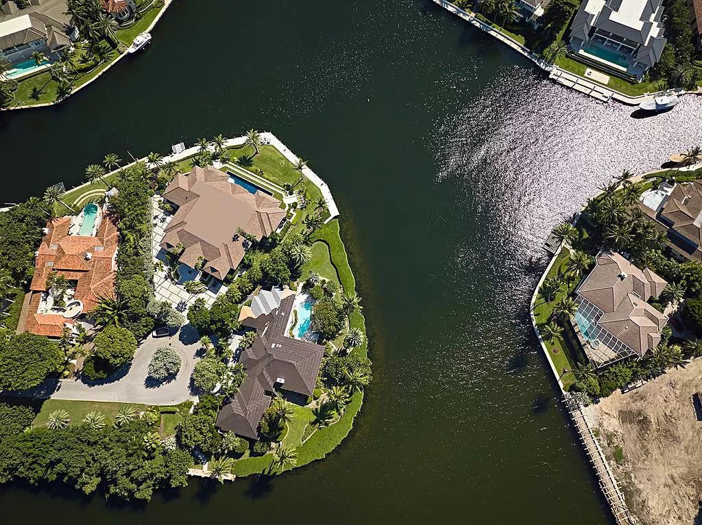Discover a newly constructed 5,700 sq ft canal-front sanctuary at 38 Sunset Cay Rd, Key Largo, FL, nestled in the prestigious Ocean Reef Club. This contemporary masterpiece offers 280 ft of seawall dockage, a 60' lap pool, and captivating outdoor entertainment areas.