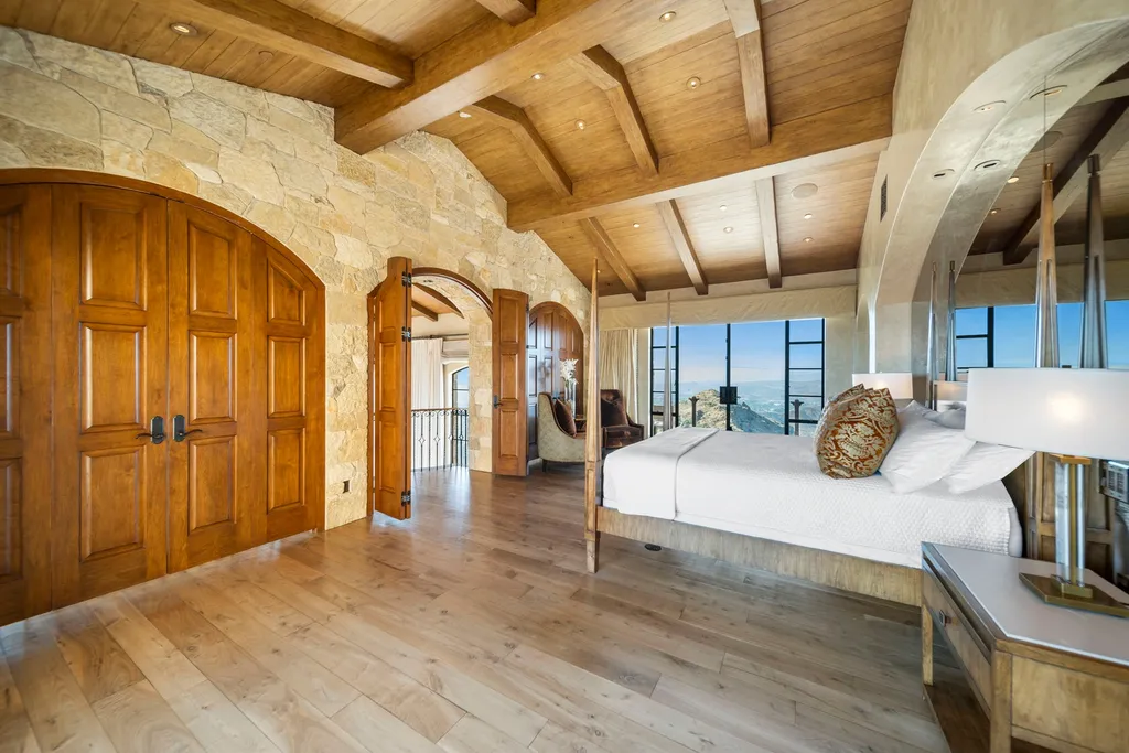 340 North Kanan Dume Road Home in Malibu, California. Perched atop a Malibu Canyon peak, the majestic Malibu Rocky Oaks is a stone-clad Tuscan villa offering unrivaled luxury and panoramic views. This 9,000-square-foot estate boasts 37 picturesque acres, a renowned vineyard, and endless world-class amenities. With a private helipad and infinity pool, this masterpiece redefines the essence of luxury living in the Malibu hills.