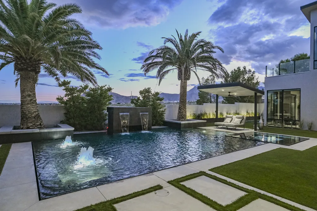 5305 Secluded Brook Court Home in Las Vegas, Nevada. Nestled within the exclusive Serenity Brook Estates at Lone Mountain, this contemporary masterpiece is a true testament to modern luxury living. Situated on a generous half-acre lot, this home offers a seamless fusion of indoor and outdoor spaces.