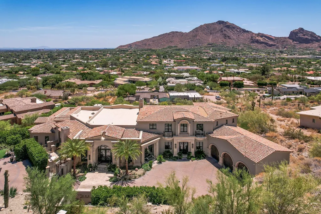 7046 North 59th Place Home in Paradise Valley, Arizona. Discover opulent living in this exquisite Paradise Valley estate offering sweeping views of Camelback Mountain and the city lights. With 7 bedrooms, 13 bathrooms, a pristine pool, and versatile entertainment spaces, this mansion is an oasis of luxury. Meticulously landscaped grounds and numerous patios provide serene outdoor retreats.