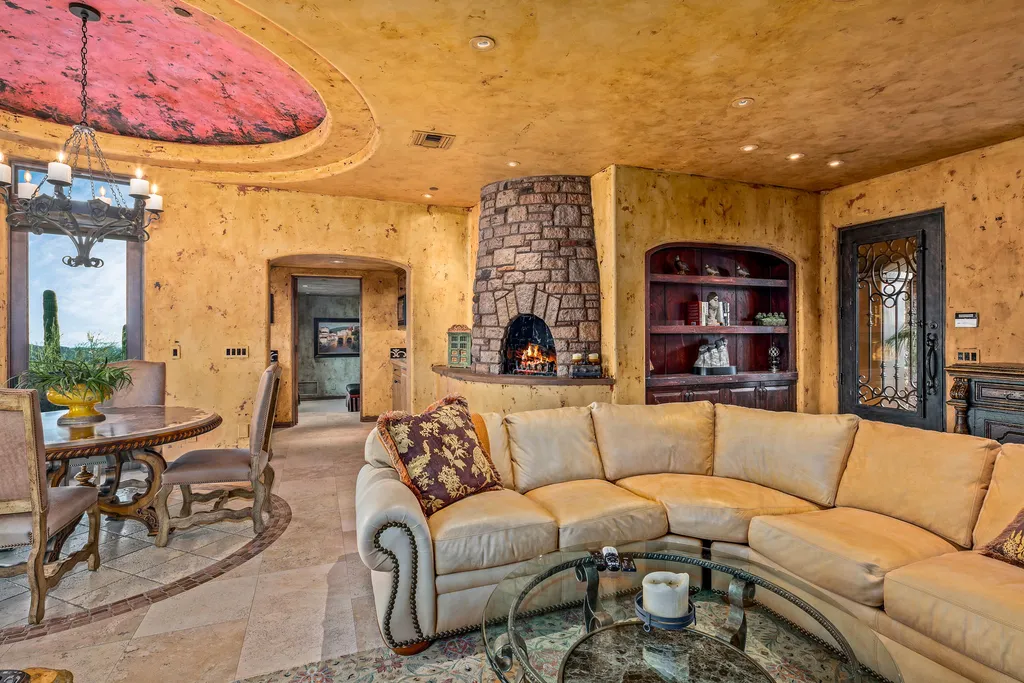 9894 East Chiricahua Pass Home in Scottsdale, Arizona. Indulge in the epitome of luxury living with this magnificent Tuscan estate in Desert Mountain. Enjoy panoramic views of mountains, sunsets, and city lights from a private and secluded lot. This comfortable and inviting home features refined finishes, five bedrooms, seven bathrooms, a full office, fitness room, elevator, and a 900-bottle wine cellar. 