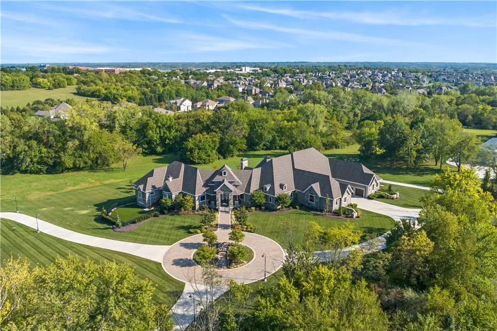 9925 West 159th Street Home in Overland Park, Kansas. Discover this modern masterpiece on 22+ private acres within the coveted Blue Valley School District. The STARR estate home, boasting nearly 14,000 sq ft of luxurious living space, features exceptional craftsmanship and high-quality materials. With 6 bedrooms, 9 bathrooms, a 6-car garage, and numerous unique amenities, this home is designed for the ultimate entertainer's dream.