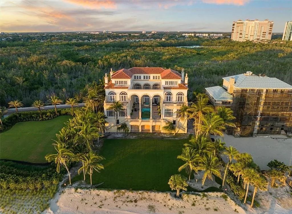 Discover an exclusive beachfront paradise at 7613 Bay Colony Drive, Naples, Florida. This 6-bed, 8-bath property spanning 12,505 square feet stands as a rare gem in the Strand at Bay Colony, offering unparalleled privacy and panoramic Gulf of Mexico views.