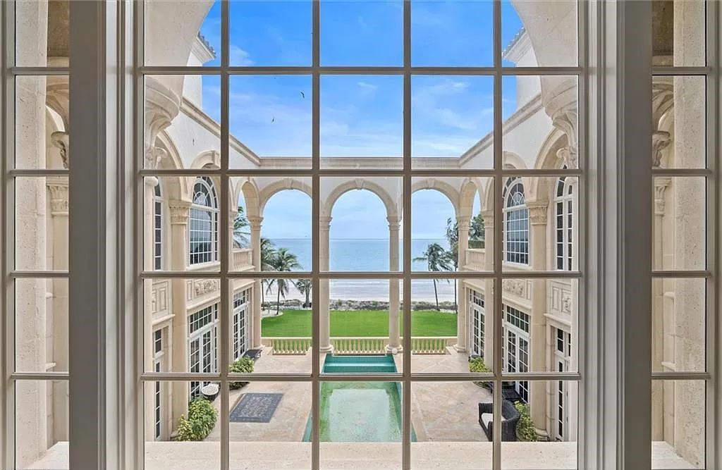 Discover an exclusive beachfront paradise at 7613 Bay Colony Drive, Naples, Florida. This 6-bed, 8-bath property spanning 12,505 square feet stands as a rare gem in the Strand at Bay Colony, offering unparalleled privacy and panoramic Gulf of Mexico views.