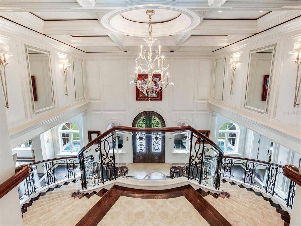 Discover luxury living at its finest in this exceptional estate at 4923 New Providence Avenue in Tampa, Florida. This magnificent property boasts unparalleled craftsmanship and opulence, from its grand entrance with 20 1/2-foot ceilings and a striking spiral staircase to its unique features like Turkish stone fireplaces, soundproofed walls, a glass elevator, and a cinema room.