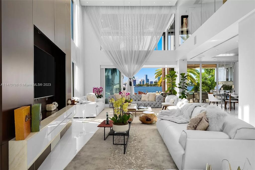 Perched on the tip of Hibiscus Island, 441 N Hibiscus Dr, Miami Beach, FL, is a contemporary masterpiece boasting 5 bedrooms and 7 bathrooms across 4,827 square feet. Offering unobstructed Miami skyline and bay views, this tri-level waterfront home features soaring ceilings, floor-to-ceiling windows, and a chef's kitchen with high-end appliances.