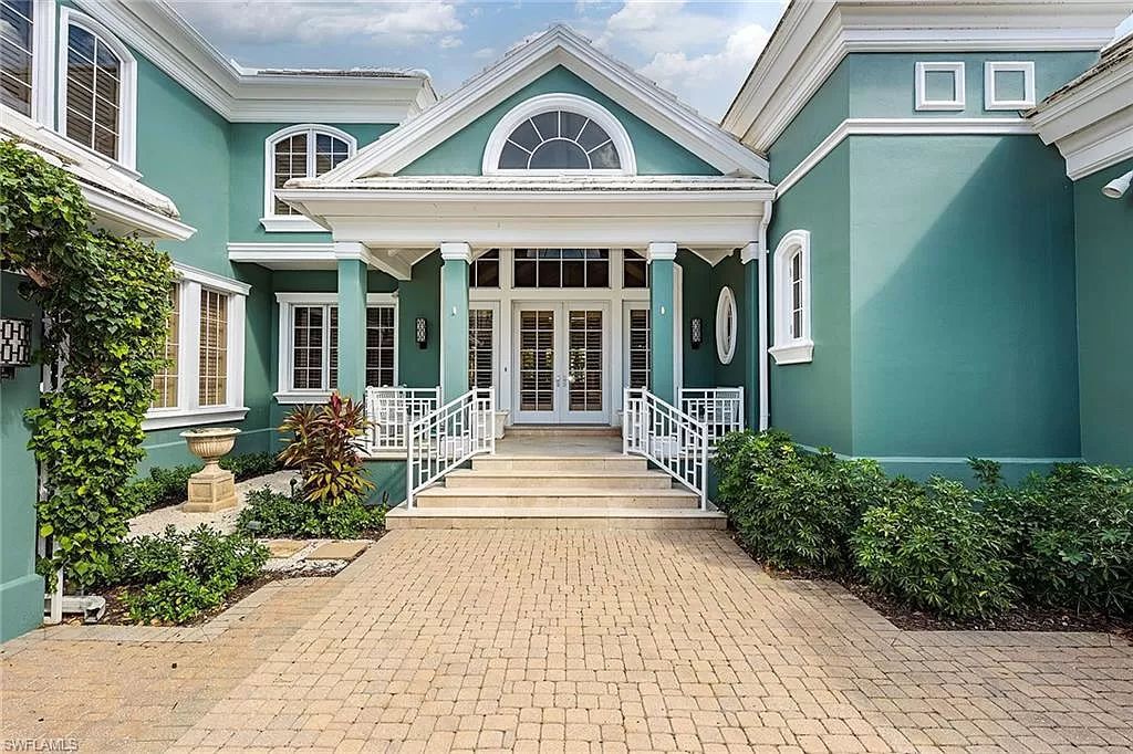 Nestled in Little Harbour, this vibrant Florida home offers downtown proximity and a coveted Port Royal membership. Enter into a spacious living and dining area with vaulted ceilings and custom cabinets. A sunroom overlooks the pool, spa, and lake through a Nana folding-glass wall, seamlessly blending indoor and outdoor spaces.