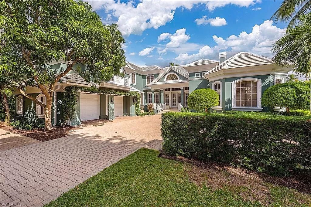 Nestled in Little Harbour, this vibrant Florida home offers downtown proximity and a coveted Port Royal membership. Enter into a spacious living and dining area with vaulted ceilings and custom cabinets. A sunroom overlooks the pool, spa, and lake through a Nana folding-glass wall, seamlessly blending indoor and outdoor spaces.