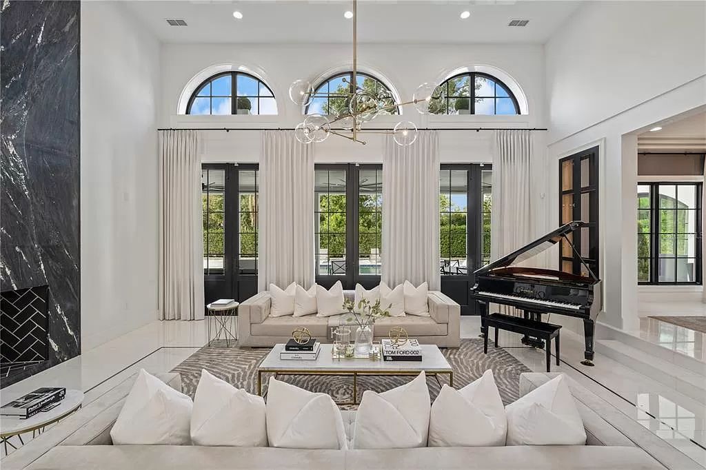 Discover Winter Park's epitome of luxury living in this architectural masterpiece by award-winning architect Larry Boerder. Just steps from Park Avenue's upscale boutiques and restaurants, this 2021-built estate boasts opulence at every turn.