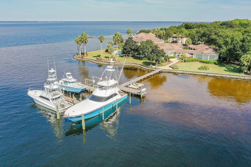 Discover the pinnacle of luxury living in this exclusive Destin estate within the prestigious Kelly Plantation subdivision. Situated on a rare 1.5-acre double lot peninsula, this Mediterranean-inspired masterpiece boasts panoramic bay views and a secure harbor for multiple large yachts.