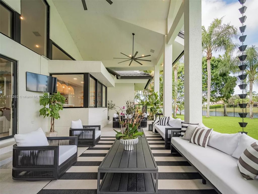 Experience the height of luxury living at 3497 Derby Ln, Weston, FL in the sought-after Windmill Ranch Estates. This fully renovated, smart home exudes modern opulence, boasting a new roof, custom impact windows, and doors