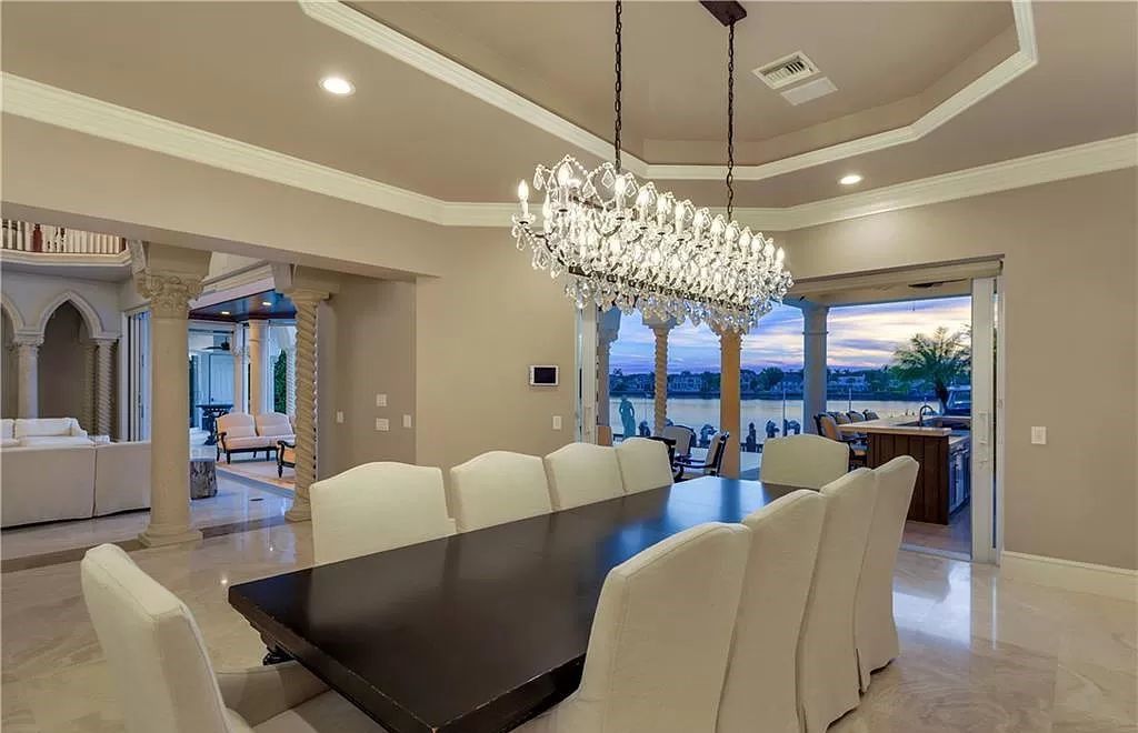 Perched in the heart of Naples, this property offers an unparalleled vista of Naples Bay and nightly breathtaking sunsets, boasting an open-concept design where water views grace every window. Recently transformed with multi-million dollar upgrades, including a luminous kitchen equipped with top-tier Wolf and Sub-Zero appliances, this home is a haven of luxury.