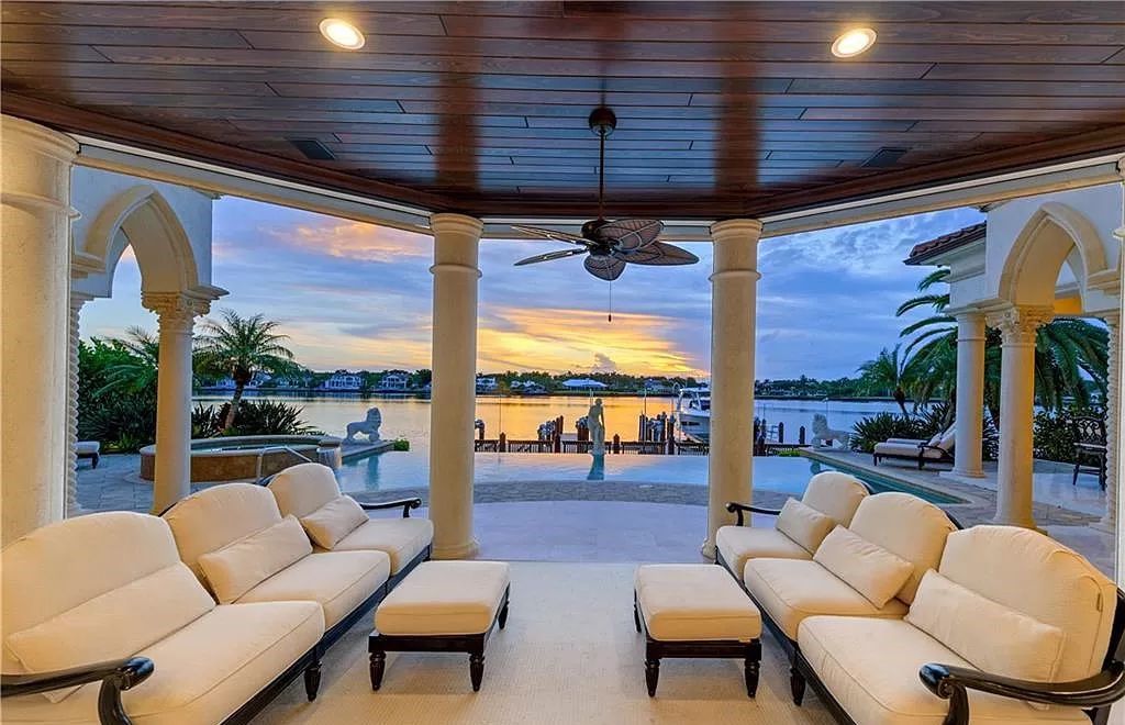 Perched in the heart of Naples, this property offers an unparalleled vista of Naples Bay and nightly breathtaking sunsets, boasting an open-concept design where water views grace every window. Recently transformed with multi-million dollar upgrades, including a luminous kitchen equipped with top-tier Wolf and Sub-Zero appliances, this home is a haven of luxury.