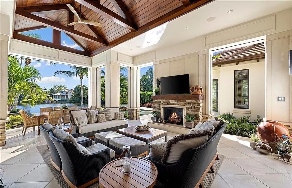 Discover the epitome of luxury living in the heart of Naples at 655 Bougainvillea Rd. This exquisite 7,660-square-foot lakefront estate, crafted by renowned architect John Cooney, boasts a seamless blend of warm tones and minimalist design.