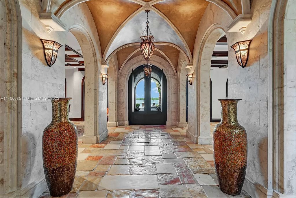 Experience the epitome of Mediterranean luxury at 230 Bal Bay Dr, an exclusive waterfront estate in Bal Harbour Village. Crafted by the esteemed Alexander Group, this custom-built masterpiece boasts exquisite details like custom millwork, Jerusalem stone flooring, and marble accents throughout.