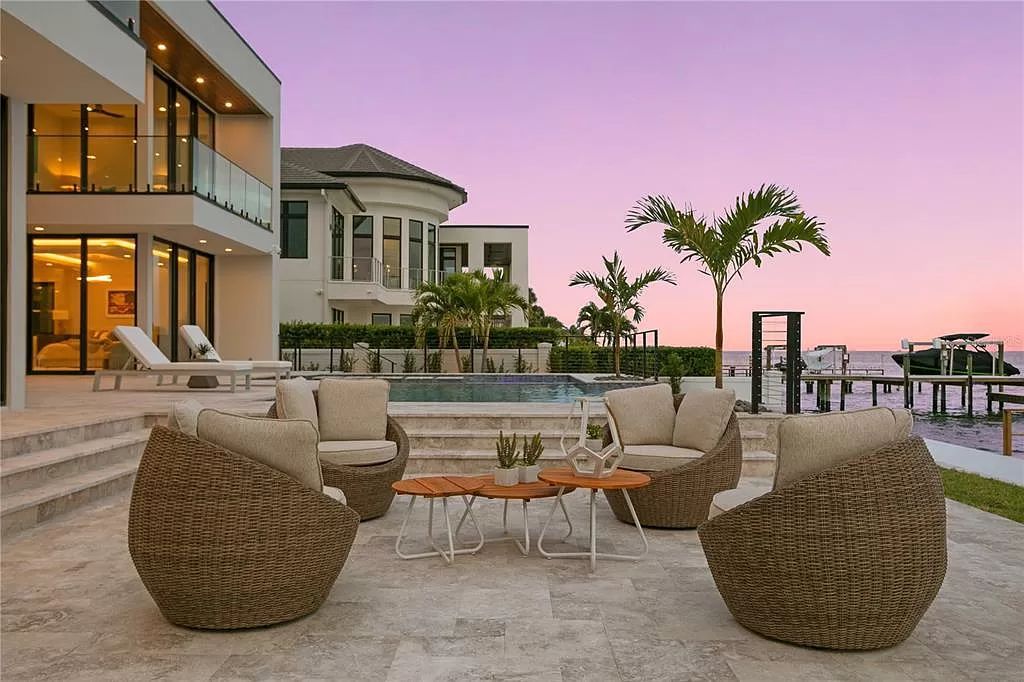 This 7,087-square-foot modern marvel at 1721 Brightwaters Blvd NE in St. Petersburg's Snell Isle boasts 100’ of Tampa Bay waterfront, offering breathtaking views. A grand entrance leads to a great room with soaring ceilings and water vistas, complemented by a chef’s kitchen and outdoor spaces ideal for entertaining.
