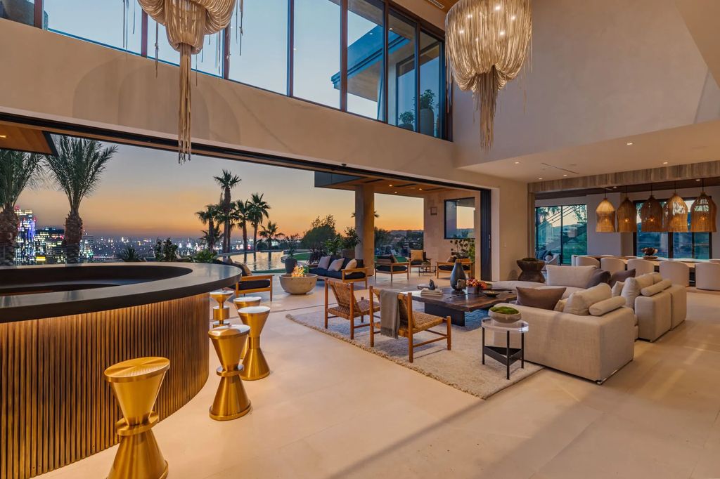 1625 Summitridge Drive Home in Beverly Hills, California. Explore this exclusive Beverly Hills estate, a gated and private oasis resembling a luxury resort. With a 24,000-sf flat lot, Balinese pool, spa, and breathtaking city/ocean views, this 19,000+ sf property offers unparalleled amenities.
