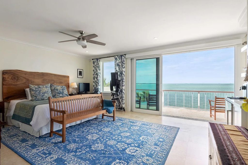 Discover unparalleled luxury at SERENITY CAY, a 3.37-acre estate in Islamorada. The gated entrance leads to lush tropical landscapes surrounding a 6,935 square feet main house with 5 lavish ensuites, 7 baths, and 6 expansive balconies.