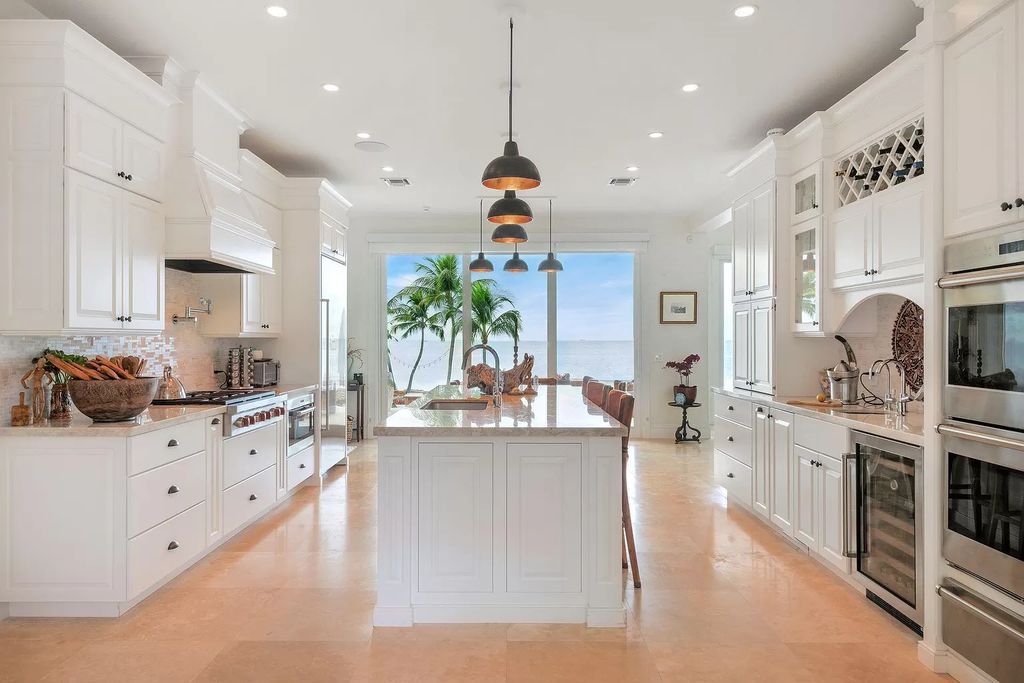 Discover unparalleled luxury at SERENITY CAY, a 3.37-acre estate in Islamorada. The gated entrance leads to lush tropical landscapes surrounding a 6,935 square feet main house with 5 lavish ensuites, 7 baths, and 6 expansive balconies.