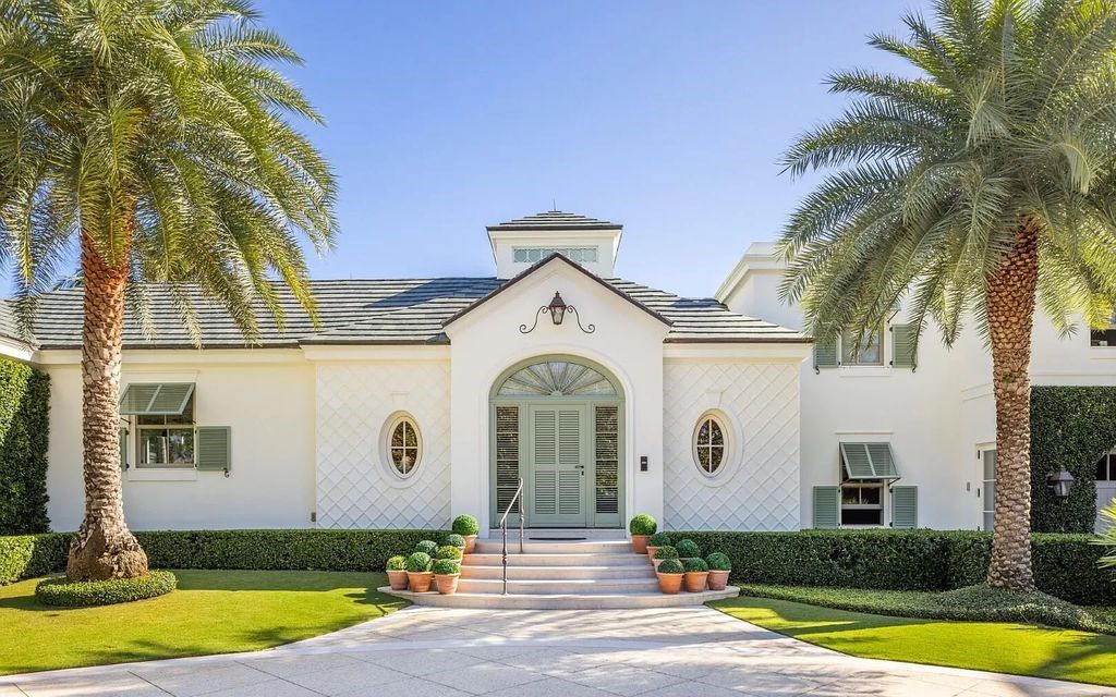 Nestled in Palm Beach's prestigious Estate Section, this 1.3+/- acre property epitomizes luxury living with a stunning clay tennis court, two guest houses, and immaculate grounds. A gated entry leads to a circular drive and ample parking, complemented by a separate service area and a 2-car garage.