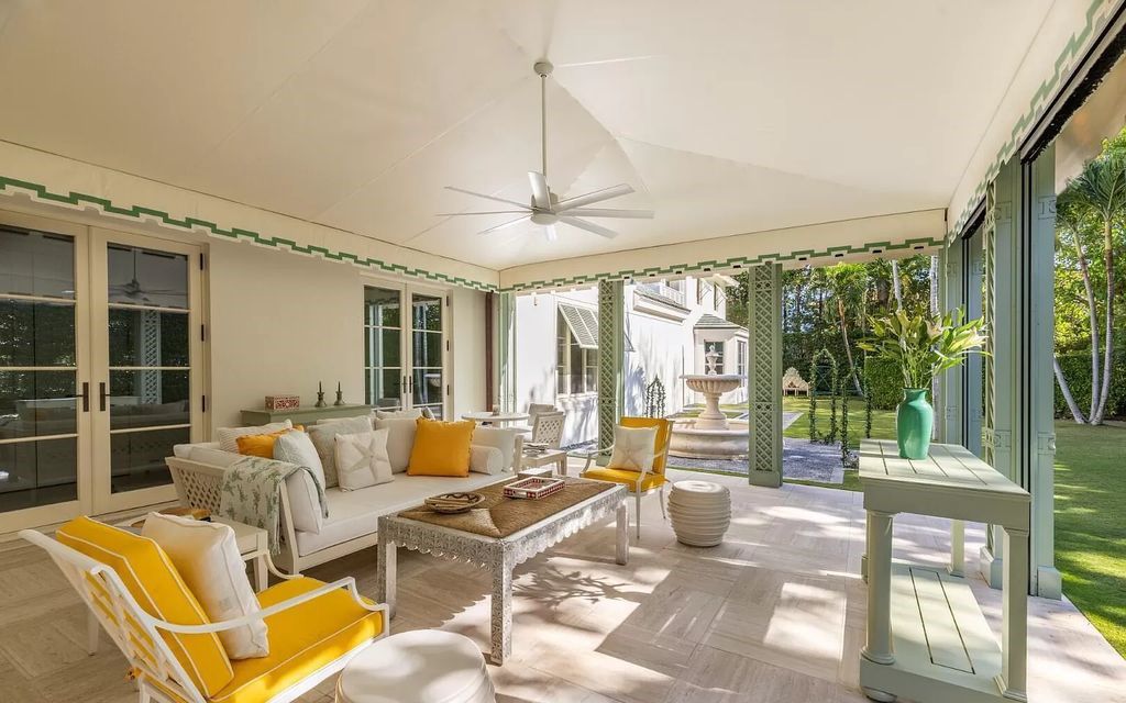 Nestled in Palm Beach's prestigious Estate Section, this 1.3+/- acre property epitomizes luxury living with a stunning clay tennis court, two guest houses, and immaculate grounds. A gated entry leads to a circular drive and ample parking, complemented by a separate service area and a 2-car garage.