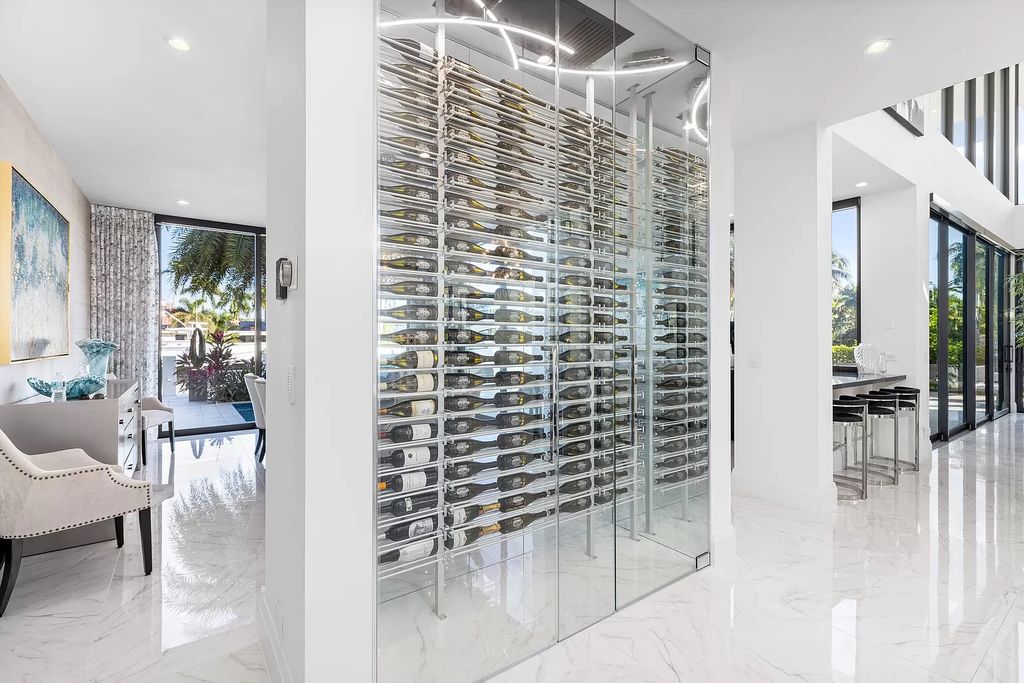 Discover the epitome of contemporary luxury living at 2 Fiesta Way, Fort Lauderdale. This exquisite three-story estate spanning 7,661 square feet includes 6 bedrooms, 7 full bathrooms, and 1 half bathroom. Its sophisticated design seamlessly blends elegance with functionality, featuring a 220-foot dock, an open layout flooded with natural light, and a glass elevator.