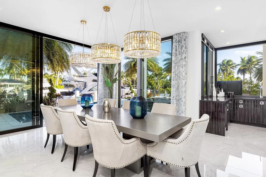 Discover the epitome of contemporary luxury living at 2 Fiesta Way, Fort Lauderdale. This exquisite three-story estate spanning 7,661 square feet includes 6 bedrooms, 7 full bathrooms, and 1 half bathroom. Its sophisticated design seamlessly blends elegance with functionality, featuring a 220-foot dock, an open layout flooded with natural light, and a glass elevator.