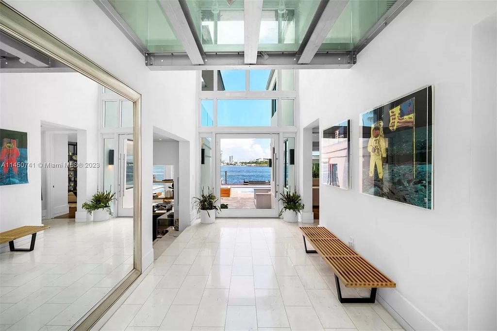 Nestled on E Rivo Alto Dr. in Miami Beach's Venetian Islands, this waterfront haven is a masterpiece. Boasting 90 feet of waterfront, the home offers an artfully designed space filled with natural light, perfect for collectors.
