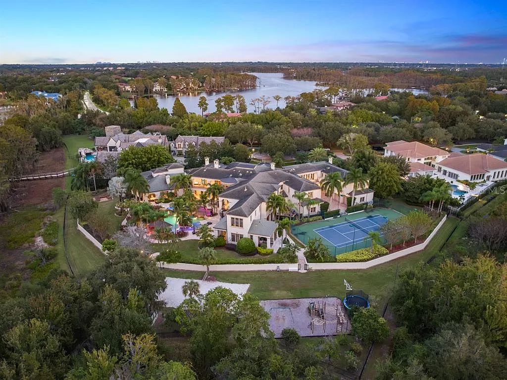 Introducing 6004 Cartmel Lane, a remarkable lakefront estate nestled on Windermere's coveted shores. Situated within the exclusive guard-gated community of The Reserve of Lake Butler Sound, this architectural masterpiece sprawls across 4.78 acres, boasting 540 feet of Lake Butler's pristine waterfront.