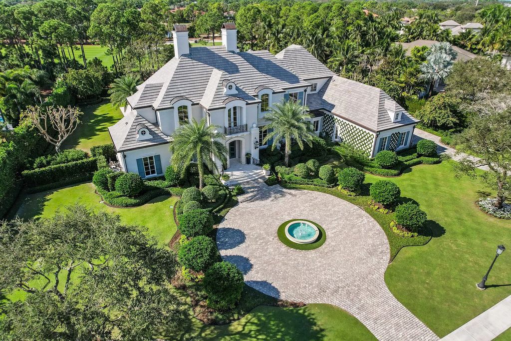 Discover European elegance at its finest within the prestigious Old Palm Golf Club at 12215 Tillinghast Cir, Palm Beach Gardens, Florida. This 1-acre estate boasts over 8,000 square feet, featuring five bedrooms, including a luxurious second-floor primary suite, two offices, a temperature-controlled wine room, elevator, attached guest house, and a four-car garage.